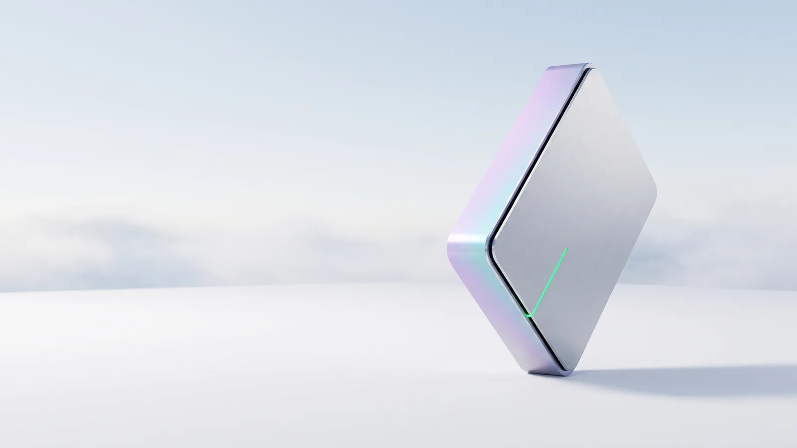 A small silver mini PC standing on one corner, with a thin green light along its edge.