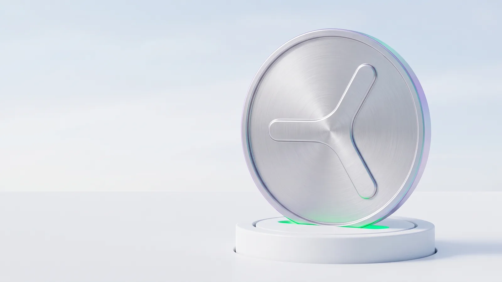 A silver coin with the YOM mark standing upright on a white pedestal lit green.