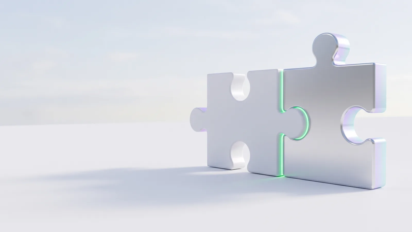 Two silver puzzle pieces joined, with a green line along the seam.
