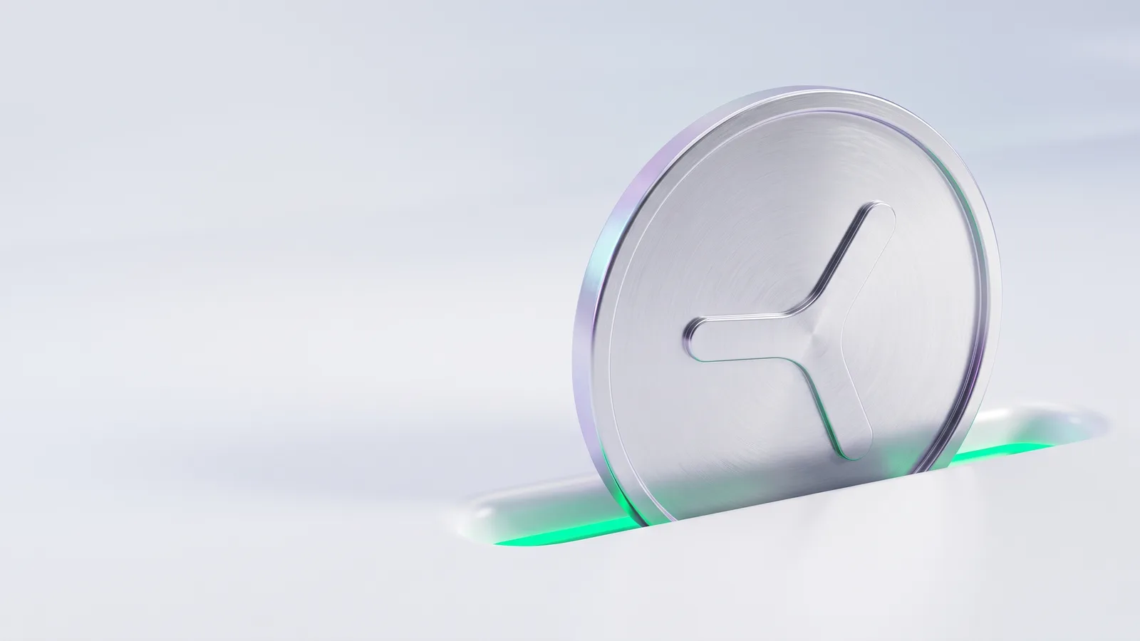 A silver coin with the YOM mark set upright in a slot in a white surface, green light in the slot.